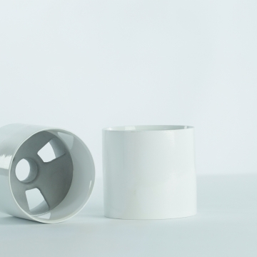 Two white premium aluminum golf cups on white background