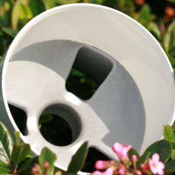 One Aluminum Golf Cup laying in a green grass